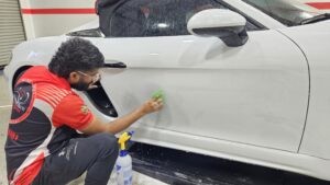 man detailing car
